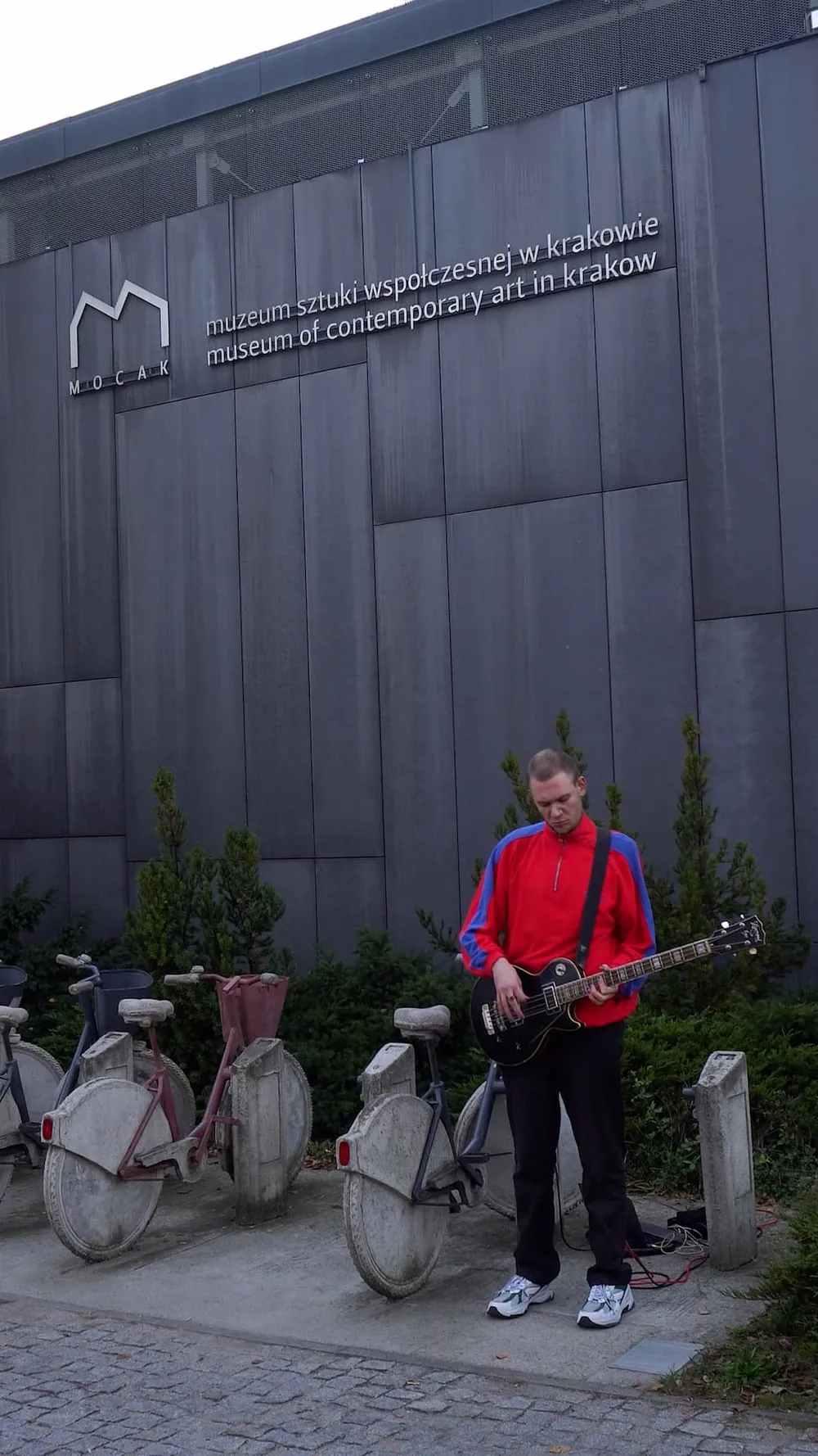Playing bass in front of a classical sculpture.