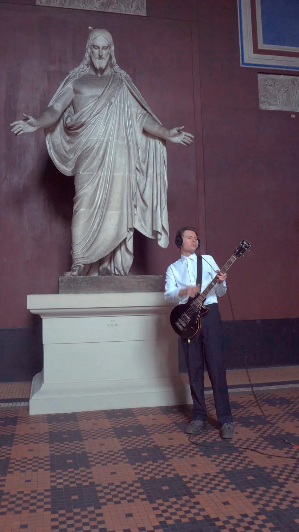 Playing bass beside a city monument.