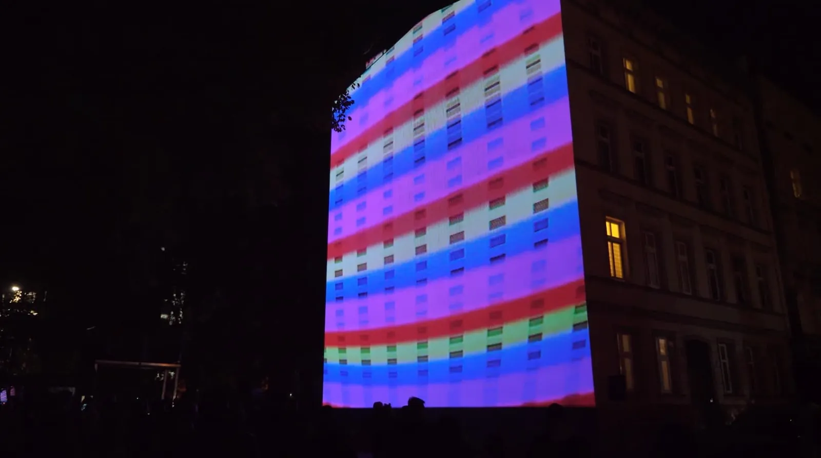 Audience watching the projection from the street.