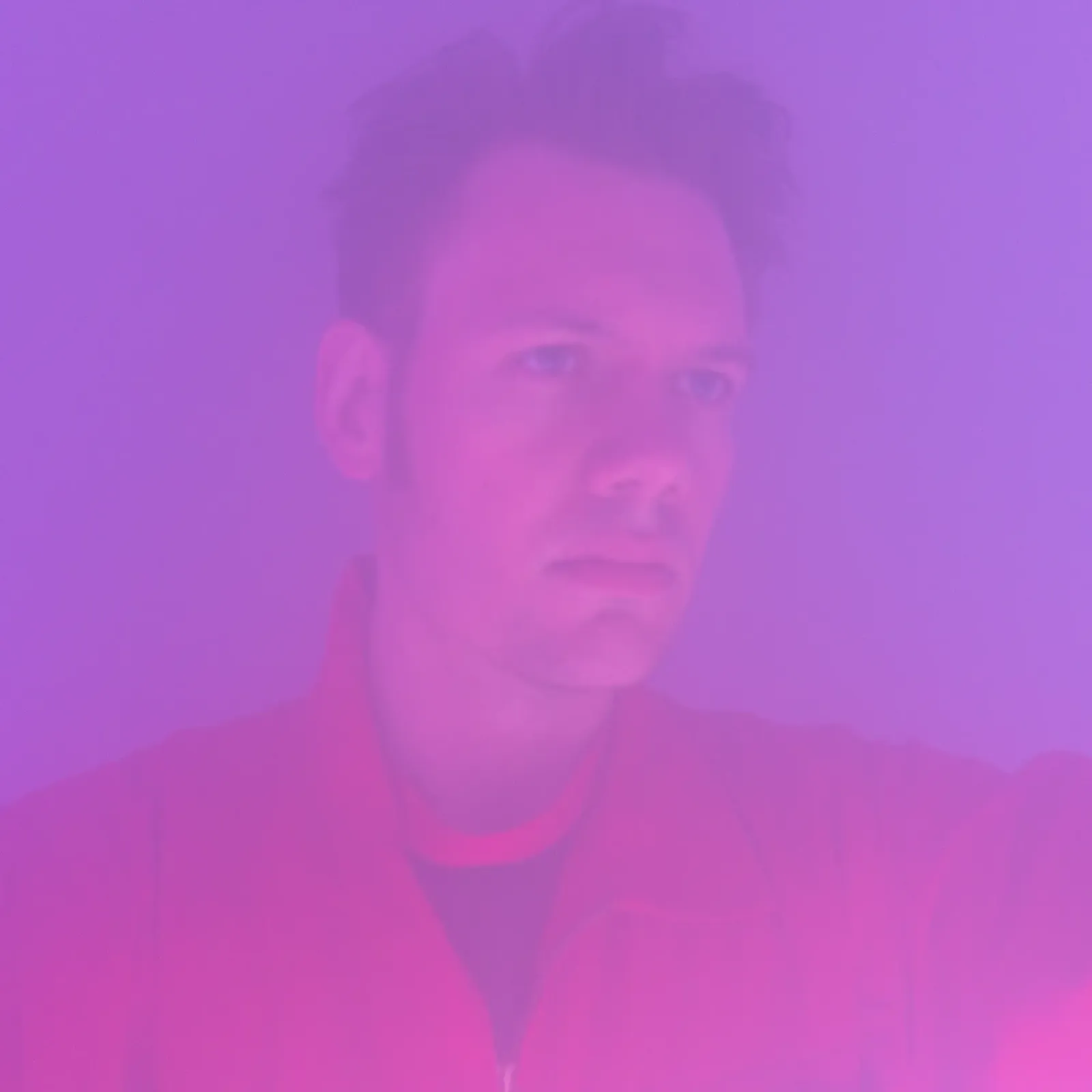 A portrait bathed in saturated magenta and violet light.
