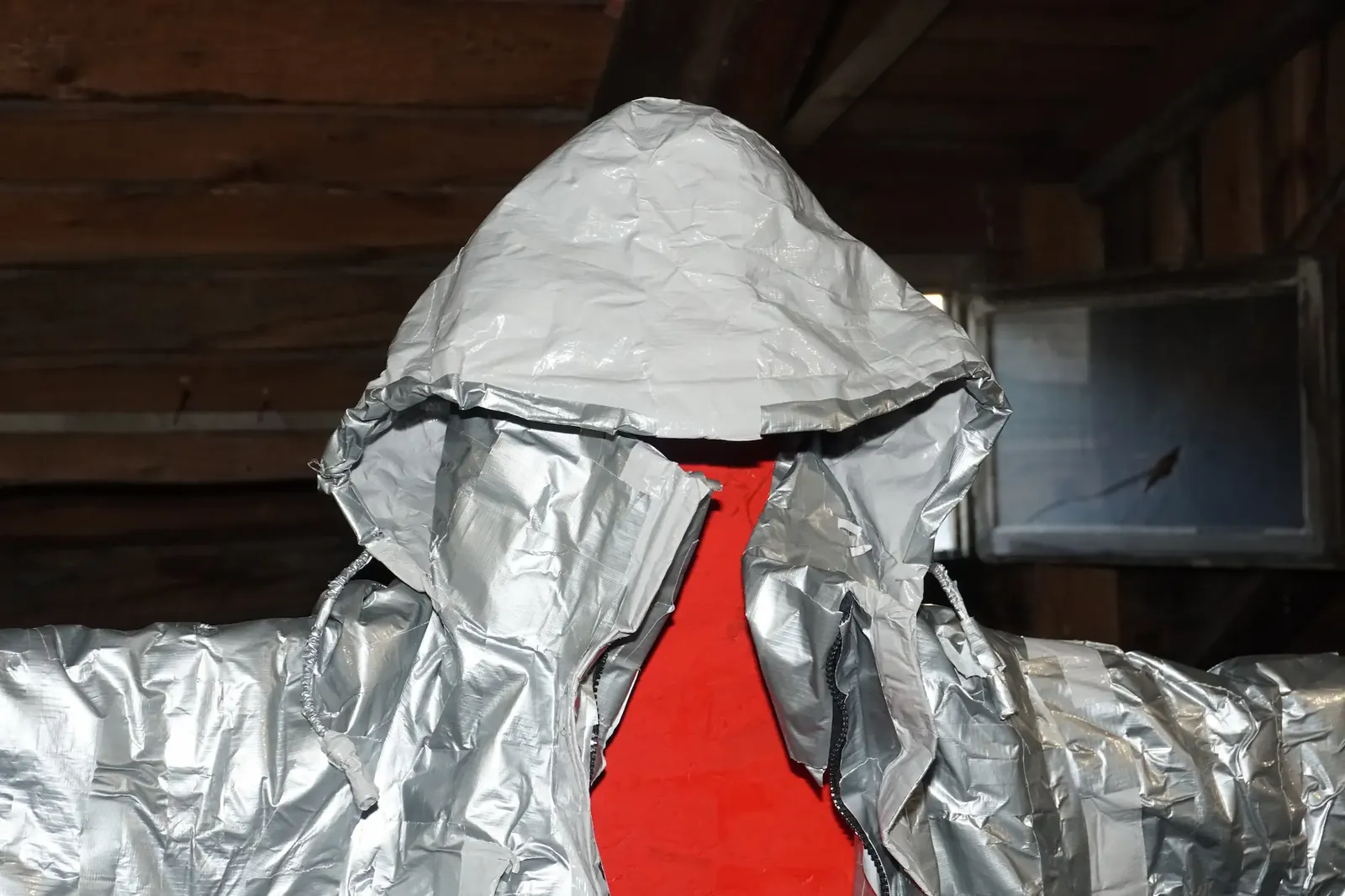 Detail of the duct-taped work suit, boots and trousers.